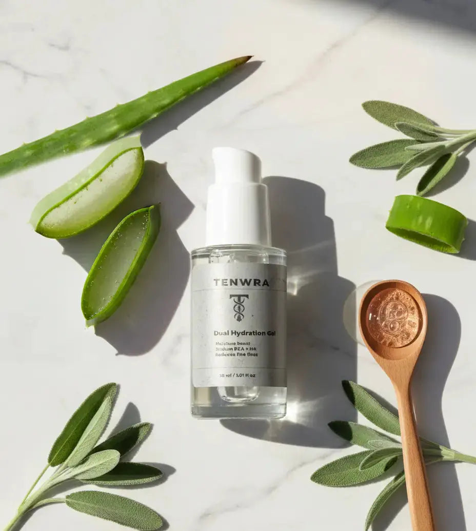 Tenwa skincare serum bottle with aloe vera leaves and a wooden spoon on a light background